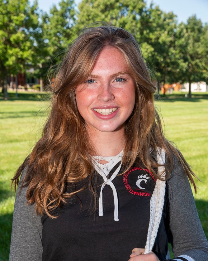Student smiling at camera outside on campus