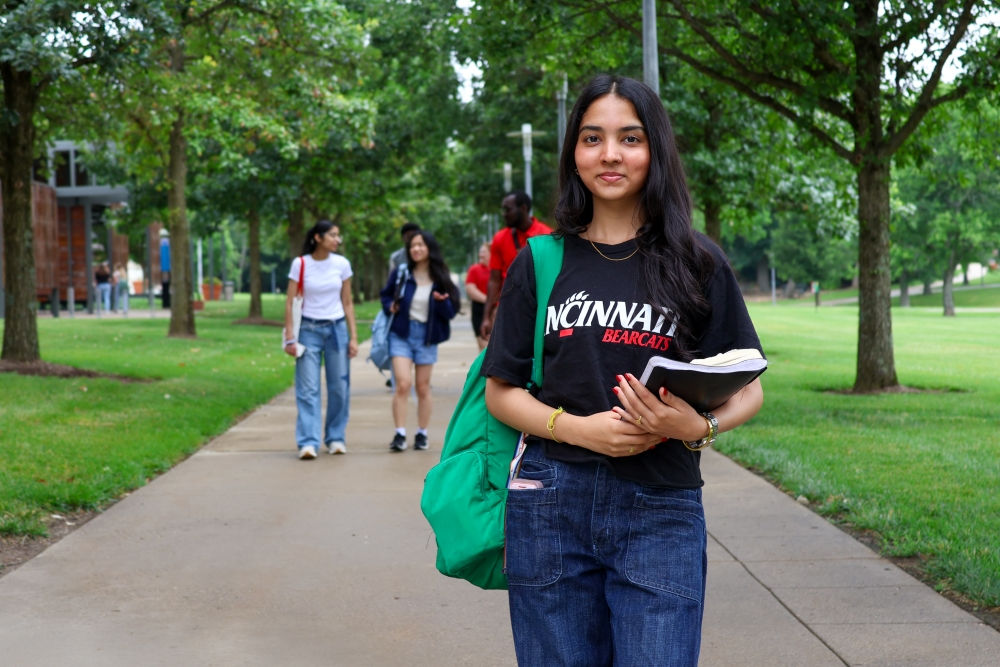 a female UC Blue Ash student and friends enjoy the UC Blue Ash campus quad