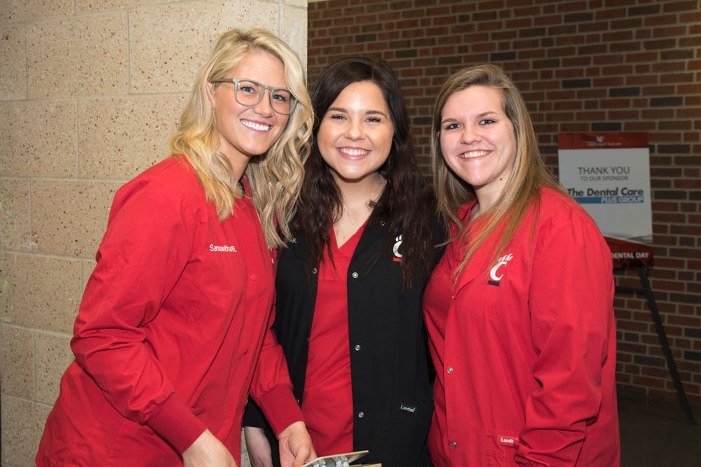 three student dental hygienists smiling