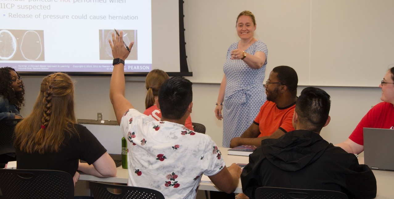 Student raising their hand in the classroom