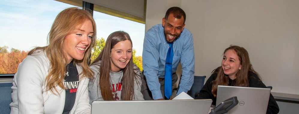 professor helping students in class