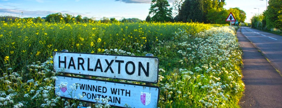 Sign for Harlaxton manor in field