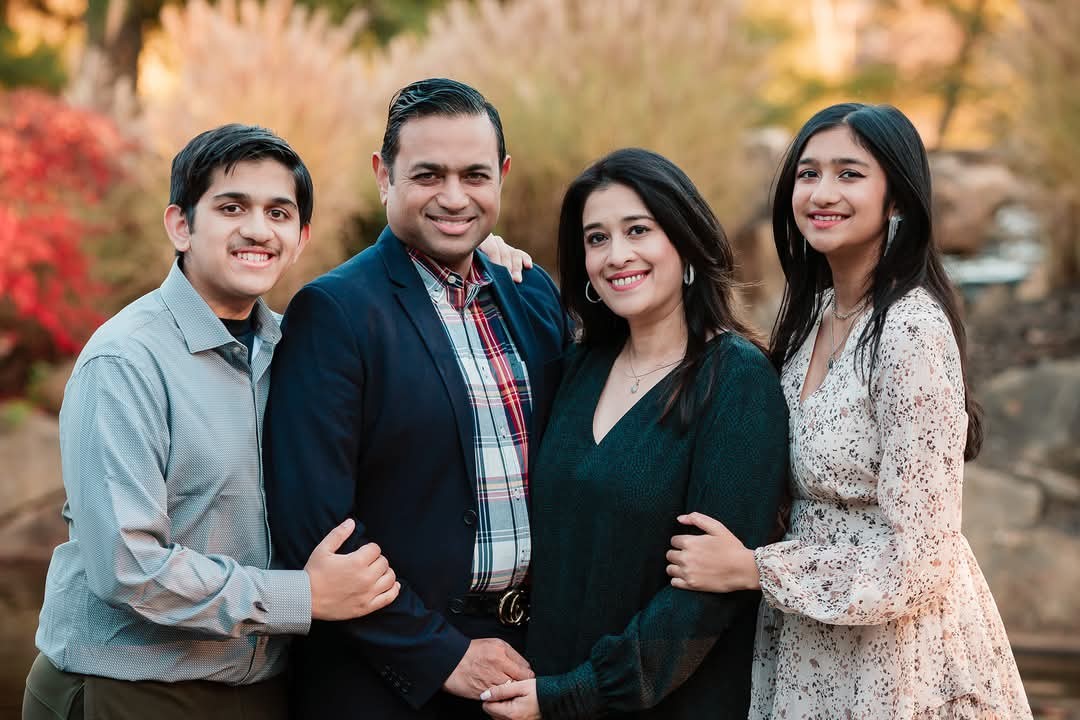 family of four smiling
