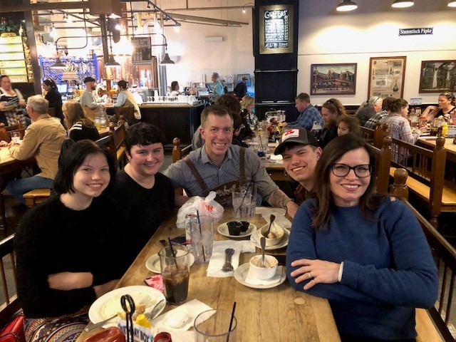 Andy Baker at a restaurant table with family