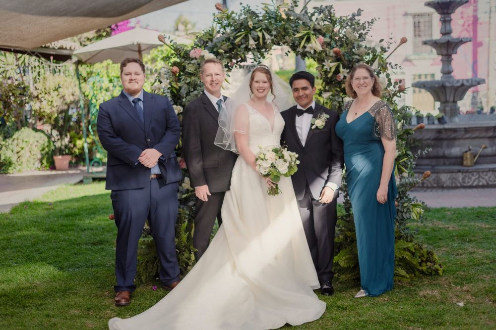 bride, groom and three other family members in wedding attire