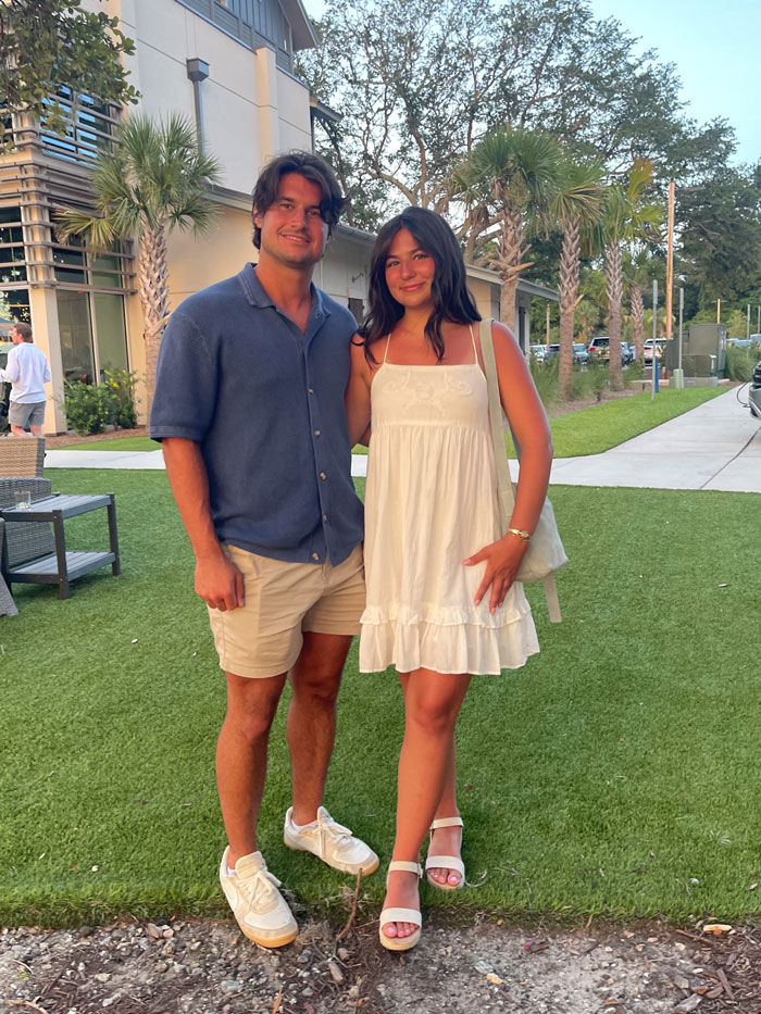 a couple posing together outdoors