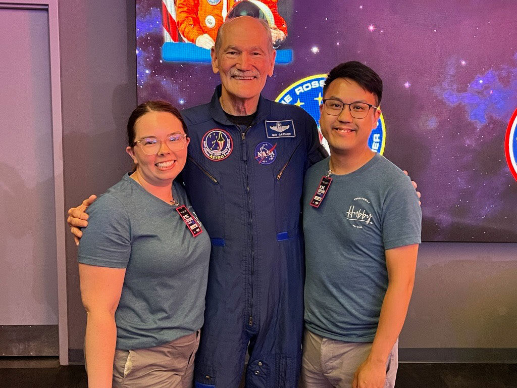 Joe Tran and wife posing with astronaut