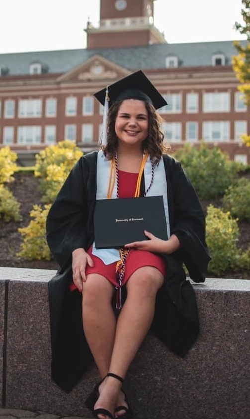woman in cap and gown with diploma