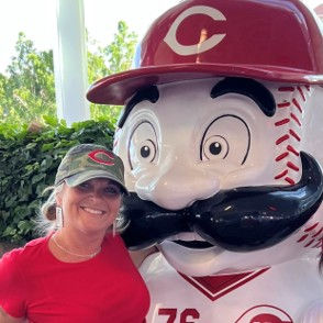 Missy Graf posing with the Cincinnati Reds mascot