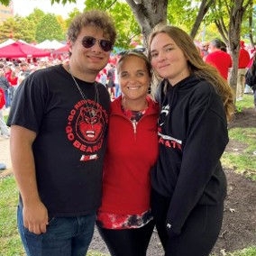 mother posing with collge-aged son and daughter outdoors