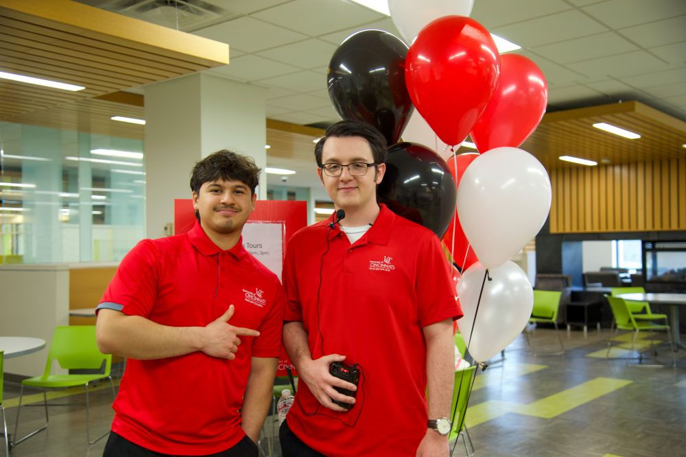 two students in red shirts in the UC Blue Ash commons