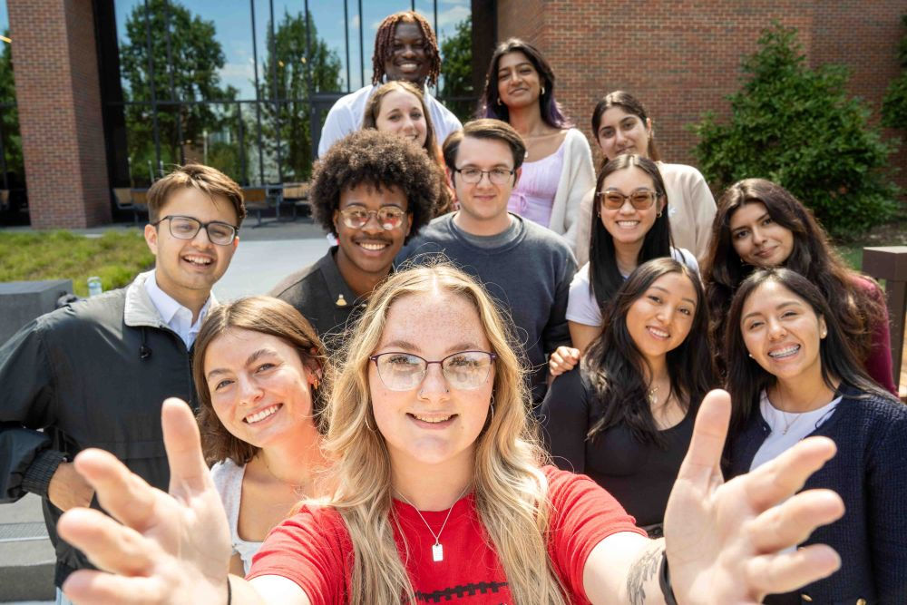 group selfie of students outdoors in the UC Blue Ash commons