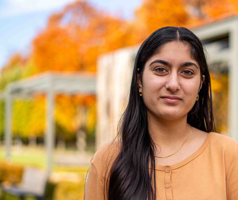Navpreet with UC Blue Ash campus in background