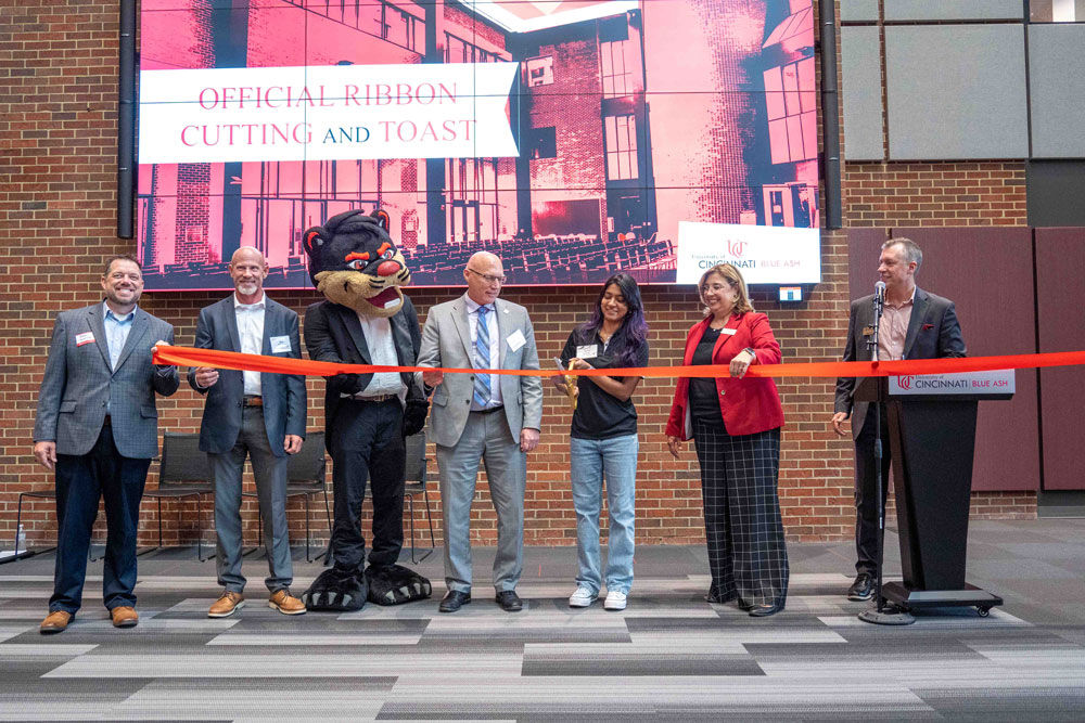 ribbon cutting ceremony with staff and students inside Muntz Hall Atrium
