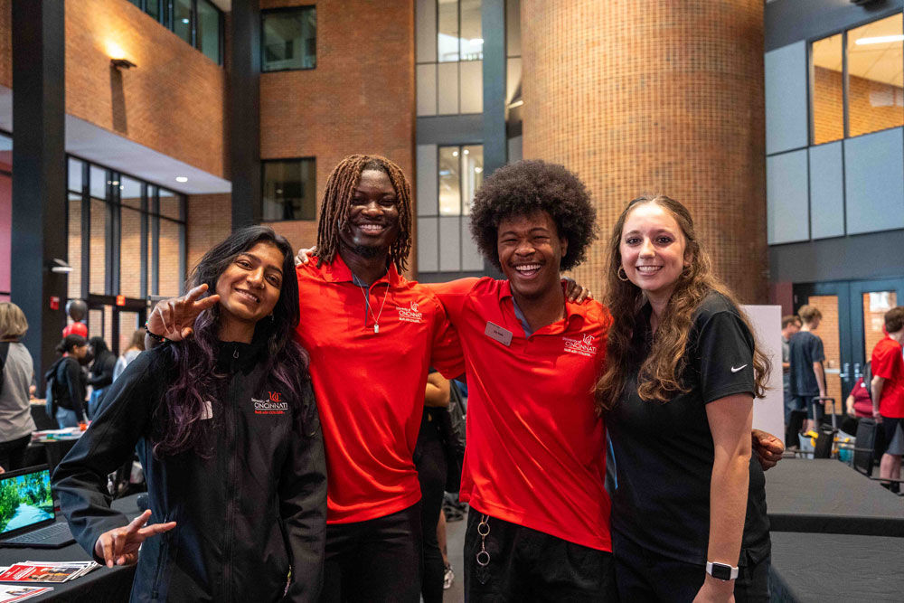 Four student workers attending an event in Muntz Hall