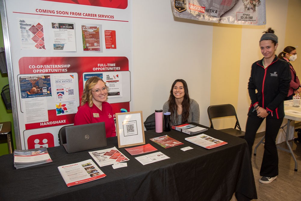Career services program director with student workers at career Fair